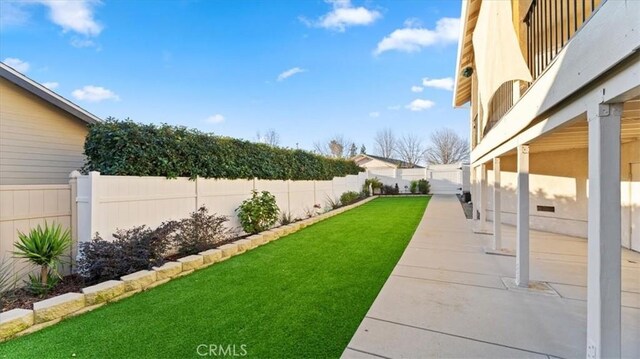 view of yard with a fenced backyard and a patio