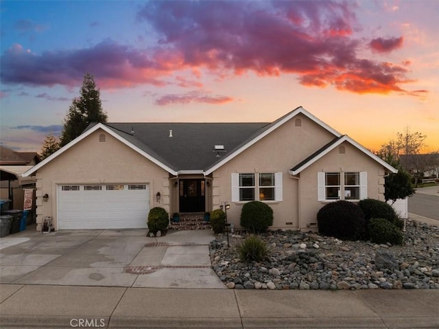 ranch-style house with concrete driveway, an attached garage, and stucco siding