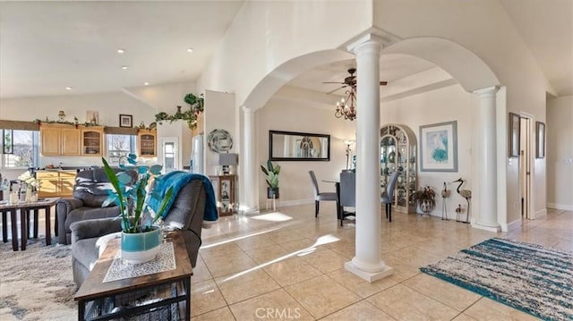 foyer entrance featuring high vaulted ceiling, arched walkways, and decorative columns