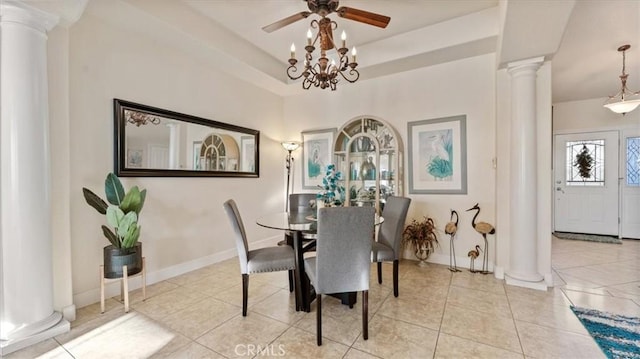 dining space with light tile patterned floors, ceiling fan, baseboards, a raised ceiling, and ornate columns