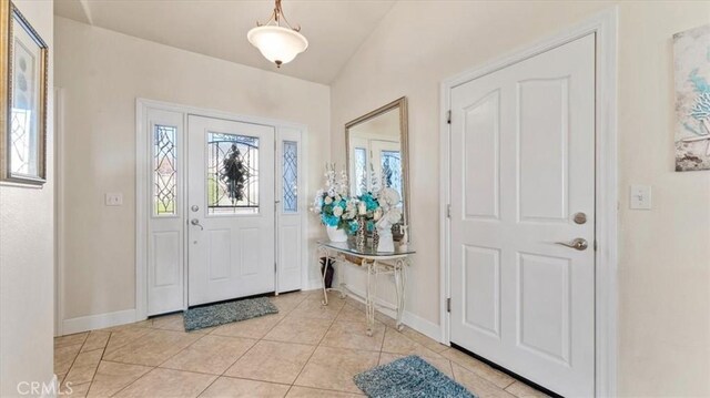 tiled foyer with vaulted ceiling