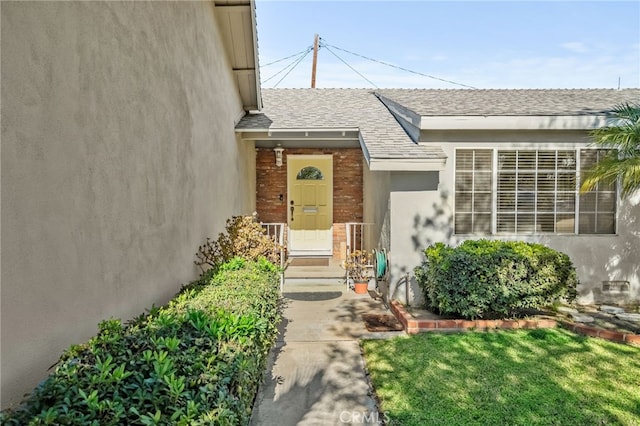 doorway to property with a yard