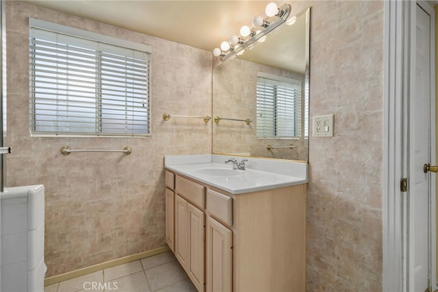 bathroom featuring tile patterned floors, vanity, and a healthy amount of sunlight