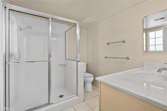 bathroom with toilet, tile patterned flooring, a shower with shower door, and vanity