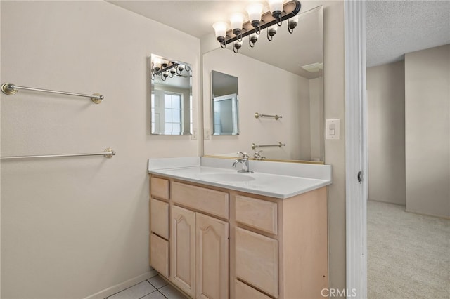 bathroom featuring a textured ceiling and vanity