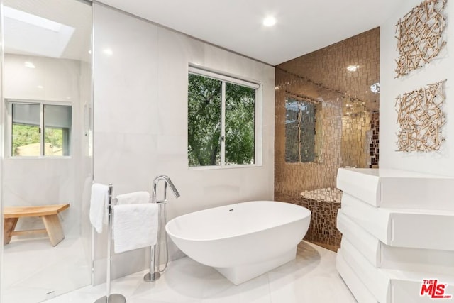 bathroom featuring tile patterned floors and a tub