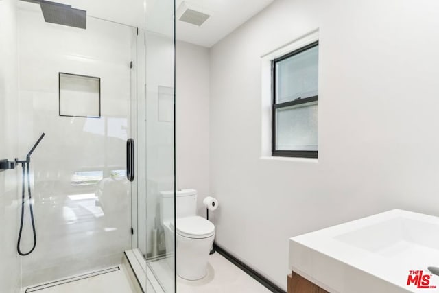 bathroom with toilet, vanity, and an enclosed shower