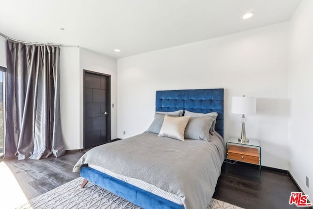 bedroom featuring dark hardwood / wood-style flooring