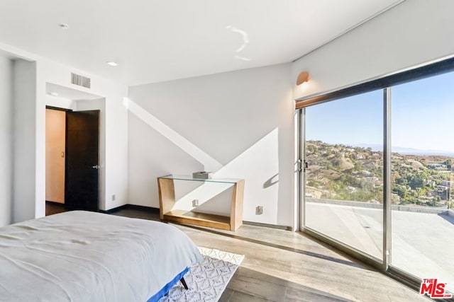 bedroom featuring hardwood / wood-style floors and access to outside