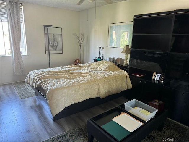 bedroom featuring ceiling fan, a textured ceiling, and hardwood / wood-style flooring