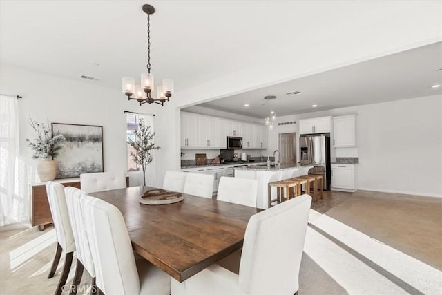 dining room with an inviting chandelier and sink