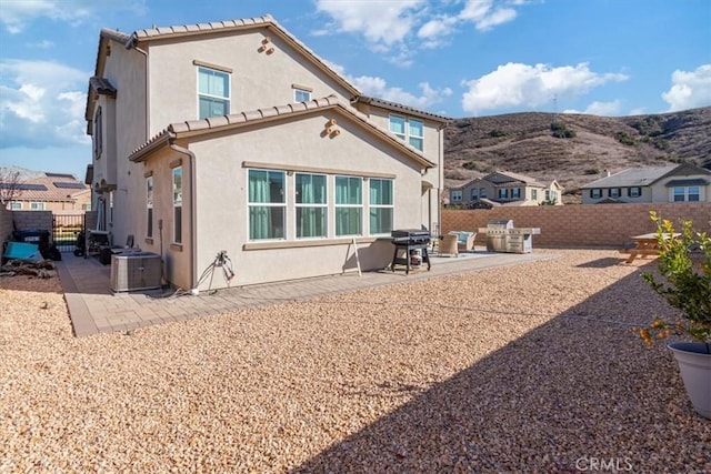 back of house featuring central AC unit and a patio