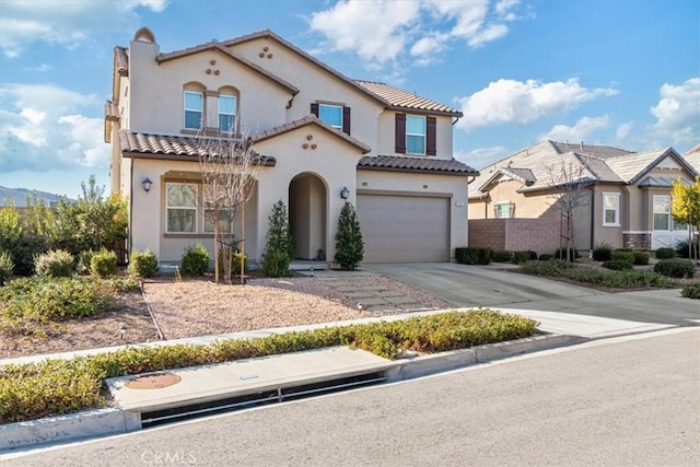 mediterranean / spanish-style house featuring a garage