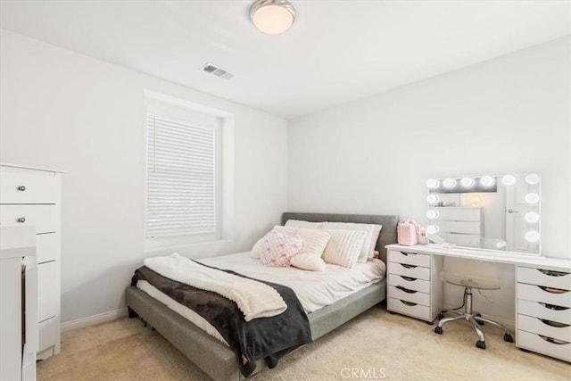 bedroom featuring light colored carpet