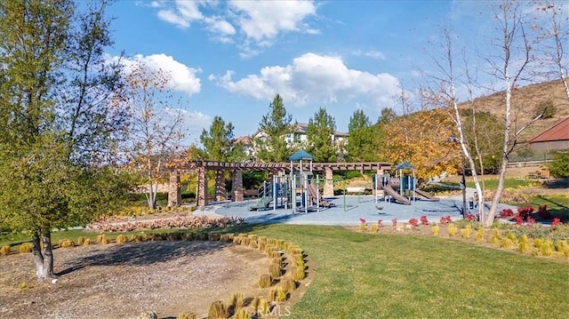 surrounding community featuring a playground and a lawn