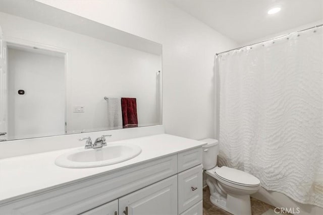 bathroom featuring toilet and vanity