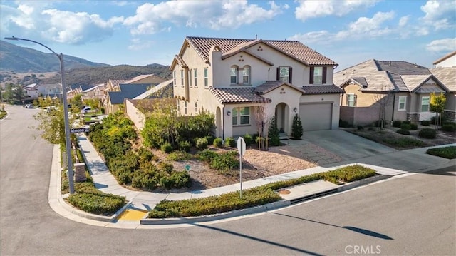 mediterranean / spanish-style house featuring a garage and a mountain view