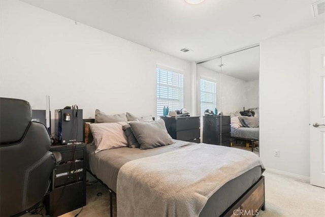 carpeted bedroom with a closet