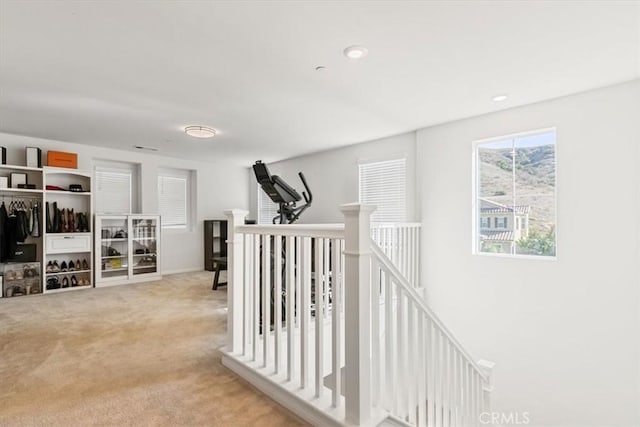 hall featuring light colored carpet