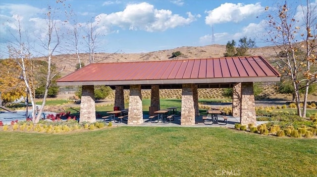 view of home's community with a gazebo, a patio area, a mountain view, and a yard