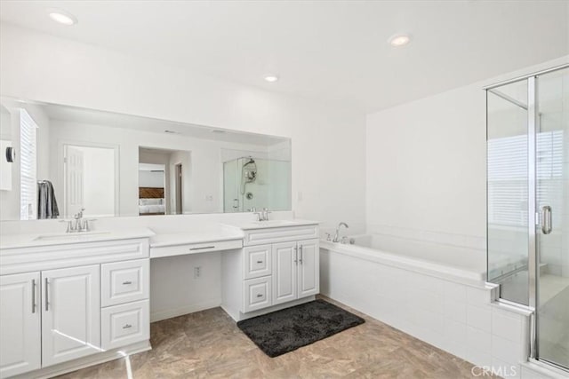 bathroom with separate shower and tub and vanity