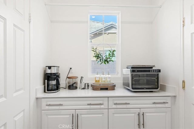 bar featuring white cabinets