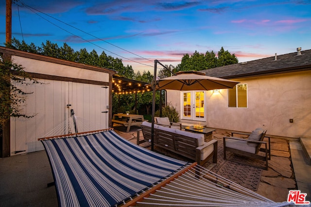 patio terrace at dusk featuring an outdoor hangout area