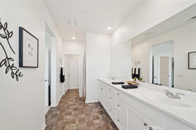 34495 Agave Dr Unit 1103, Winchester, CA 92596 - bathroom with double vanity, baseboards, visible vents, and a sink