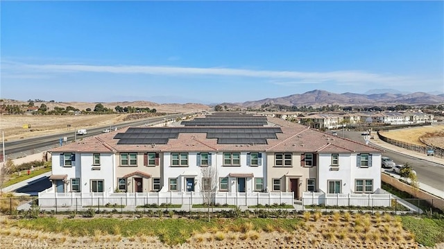 34495 Agave Dr Unit 1103, Winchester, CA 92596 - exterior space featuring fence private yard, roof mounted solar panels, a mountain view, and stucco siding