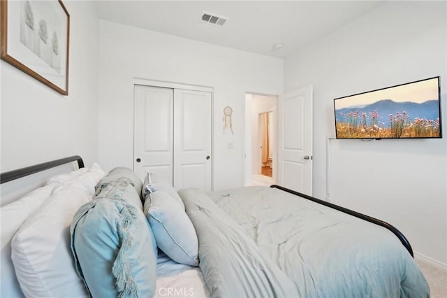 bedroom with light colored carpet and a closet