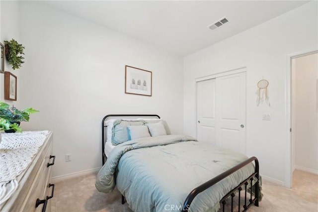 bedroom featuring light colored carpet and a closet