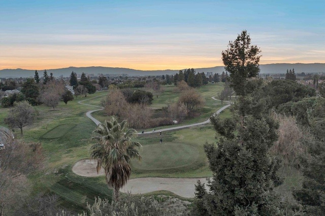 aerial view at dusk featuring a mountain view