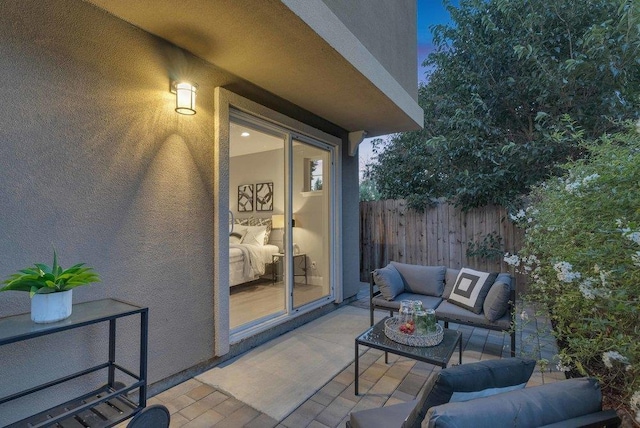 patio terrace at dusk featuring an outdoor living space