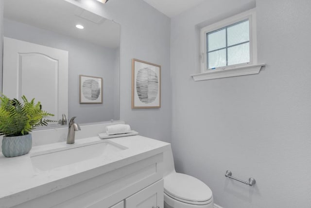 bathroom featuring toilet and vanity