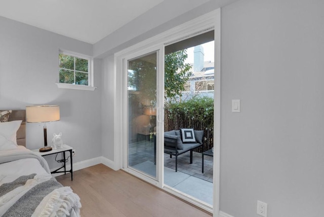 bedroom featuring light hardwood / wood-style flooring and access to outside