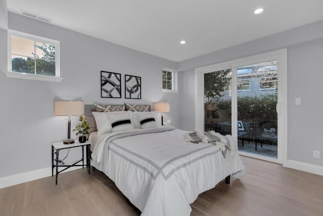 bedroom featuring hardwood / wood-style flooring and access to outside