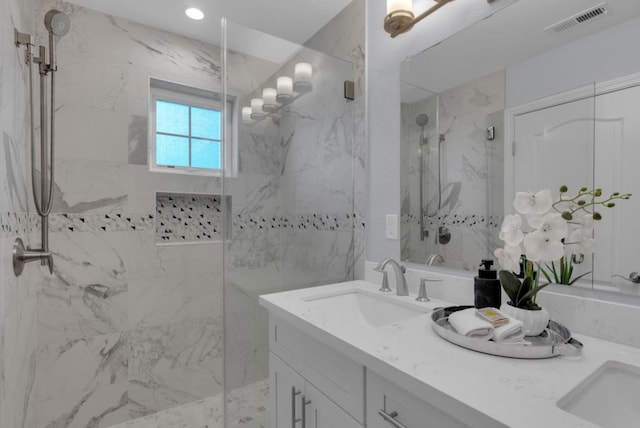 bathroom featuring walk in shower and vanity