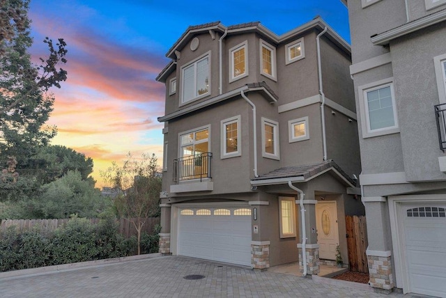 view of front of house with a garage and a balcony