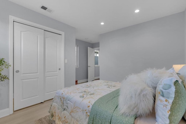 bedroom with a closet and light hardwood / wood-style flooring