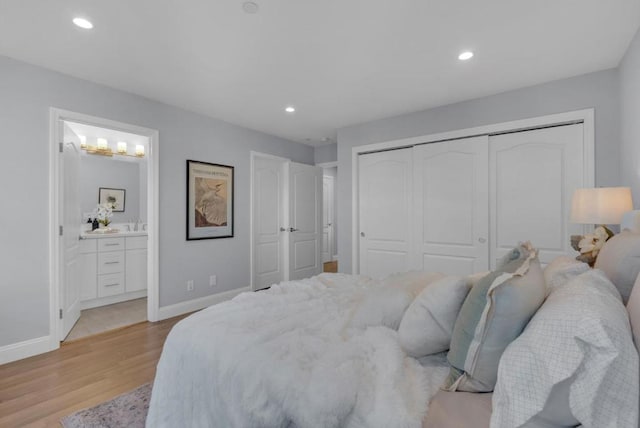 bedroom with connected bathroom, a closet, and light wood-type flooring