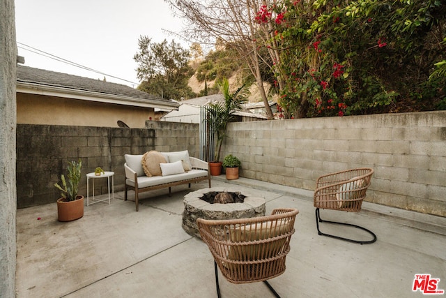 view of patio / terrace featuring an outdoor living space with a fire pit