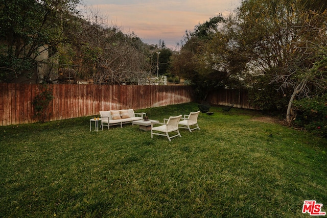 yard at dusk with outdoor lounge area