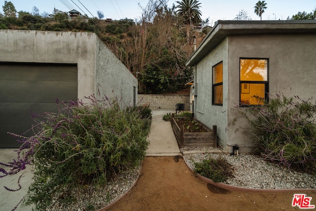 view of home's exterior with a garage and central AC unit