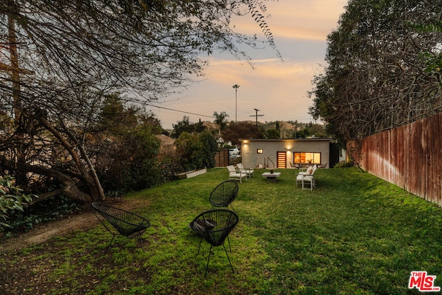 view of yard at dusk