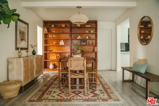 dining area featuring hardwood / wood-style floors and beamed ceiling