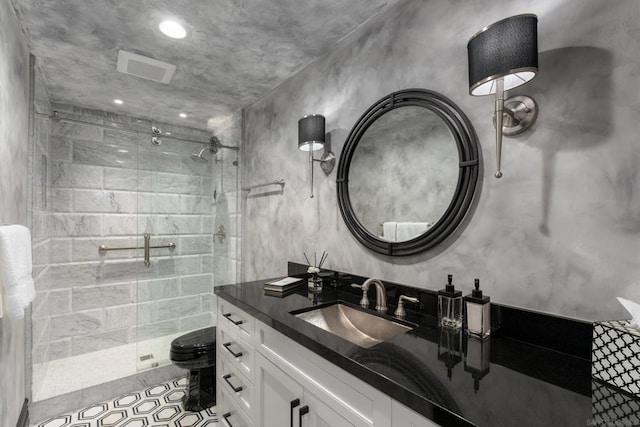 bathroom with vanity, a shower with shower door, tile patterned floors, and toilet