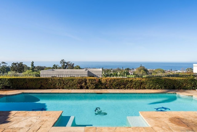 view of swimming pool with a water view