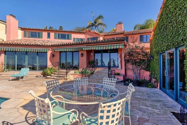 rear view of property featuring a patio