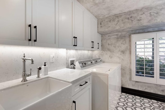 laundry room with sink, separate washer and dryer, and cabinets