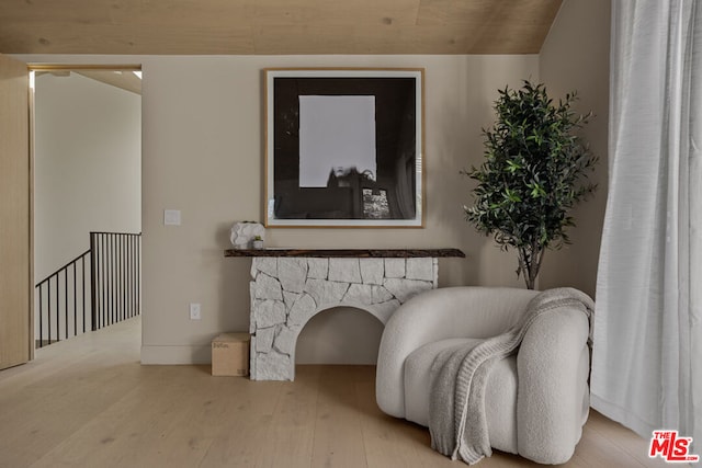 sitting room featuring hardwood / wood-style flooring and vaulted ceiling